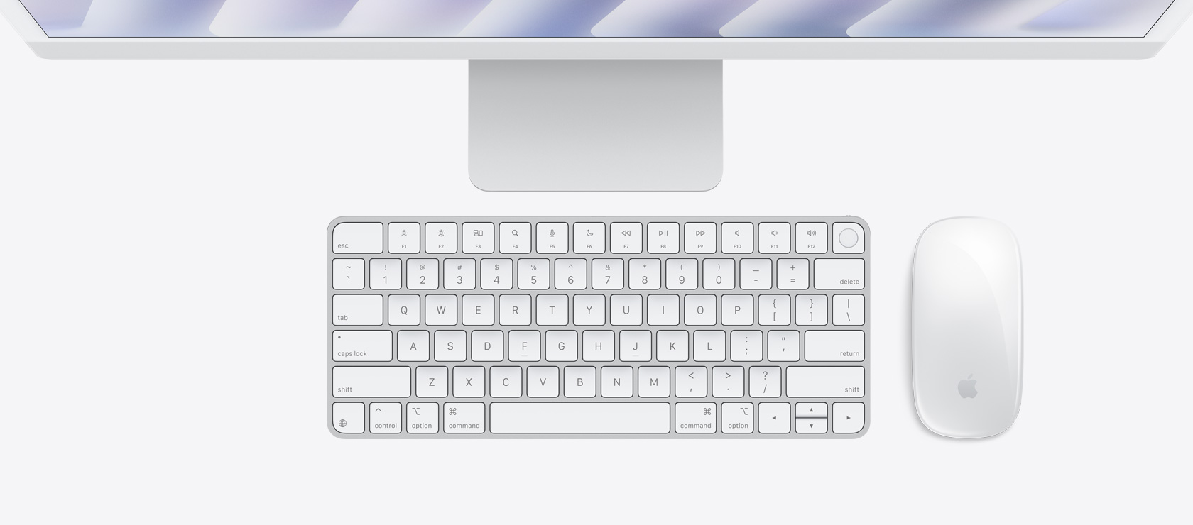 Overhead view of silver iMac with colour-matching mouse and keyboard