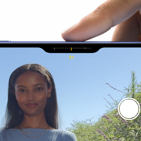 A finger slides along the Camera Control button to adjust the zoom